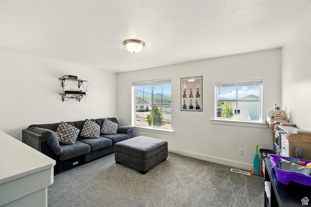 carpeted living room with baseboards