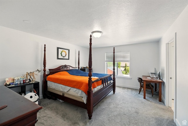bedroom with carpet, a textured ceiling, and baseboards