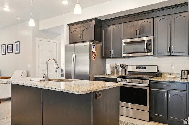 kitchen with stainless steel appliances, a sink, light stone countertops, pendant lighting, and recessed lighting