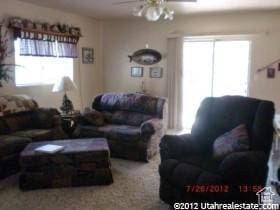 living area featuring a ceiling fan