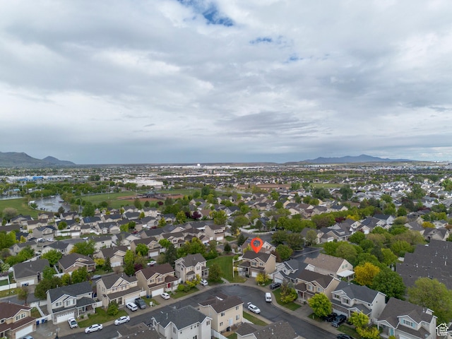 aerial view of property and surrounding area with a mountain backdrop and nearby suburban area