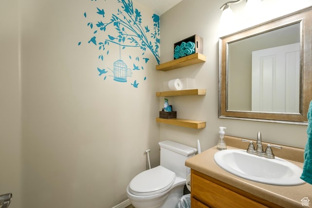 half bathroom featuring toilet and vanity