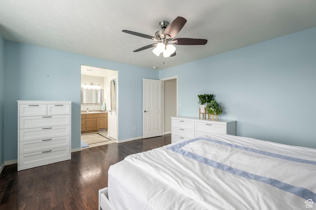 bedroom featuring dark wood-style flooring, baseboards, a ceiling fan, and ensuite bath