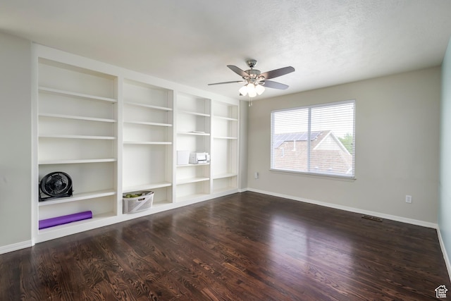 unfurnished living room with baseboards, wood finished floors, and a ceiling fan