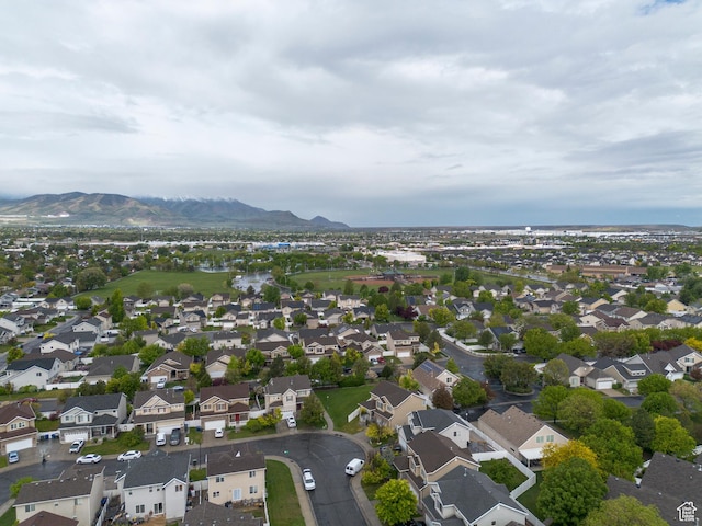 aerial overview of property's location with a mountain backdrop and nearby suburban area