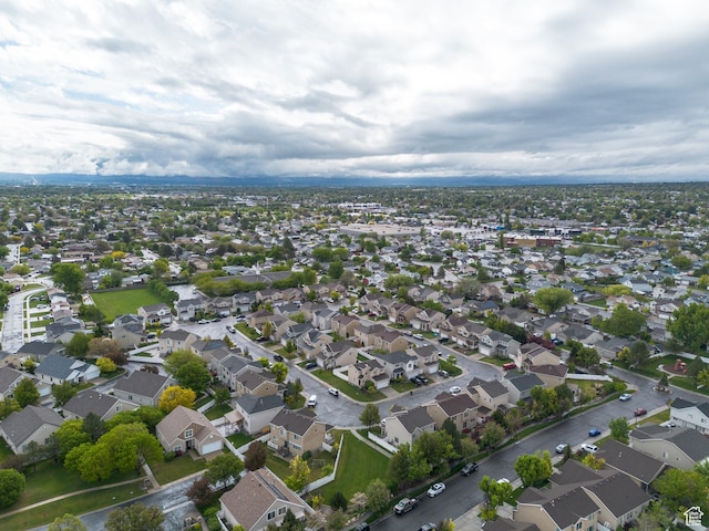 aerial view of property and surrounding area featuring nearby suburban area