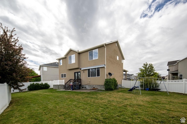 back of house with a playground and stucco siding