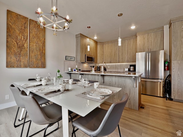 310 N N Hwy Unit 22A, Brian Head, UT 84719 - dining space featuring light wood-type flooring, a chandelier, baseboards, and recessed lighting