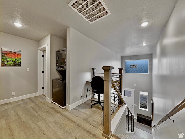 310 N N Hwy Unit 22A, Brian Head, UT 84719 - office area featuring stacked washing machine and dryer, a textured ceiling, light wood-style floors, baseboards, and recessed lighting