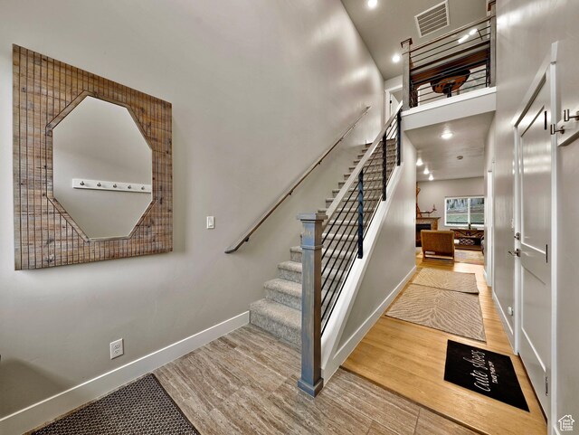 310 N N Hwy Unit 22A, Brian Head, UT 84719 - staircase with wood finished floors, baseboards, recessed lighting, and a high ceiling