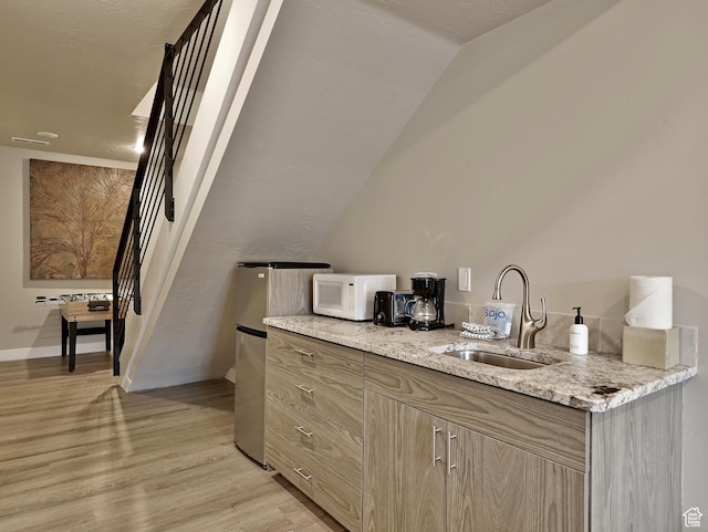 310 N N Hwy Unit 22A, Brian Head, UT 84719 - bar with a sink, white microwave, light wood-style flooring, and vaulted ceiling
