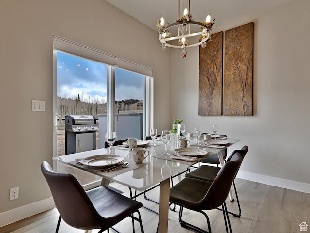 310 N N Hwy Unit 22A, Brian Head, UT 84719 - dining area with a chandelier, baseboards, and light wood-style floors