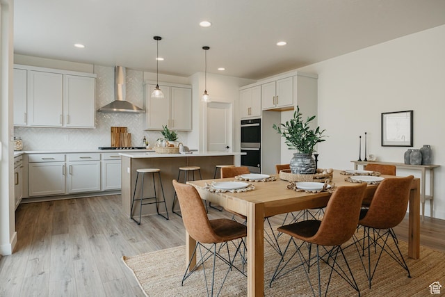 dining room featuring light wood-type flooring and recessed lighting