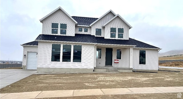 view of front facade featuring a porch, concrete driveway, and an attached garage