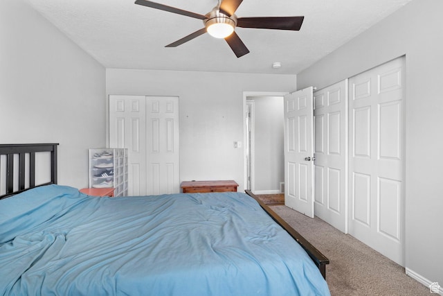 carpeted bedroom featuring baseboards and a ceiling fan