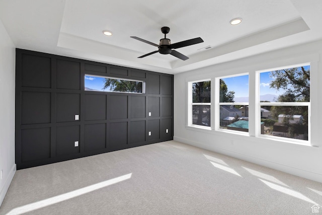 705 N Brooke Ave, Tooele, UT 84074 - unfurnished bedroom with a tray ceiling, a decorative wall, carpet floors, recessed lighting, and ceiling fan