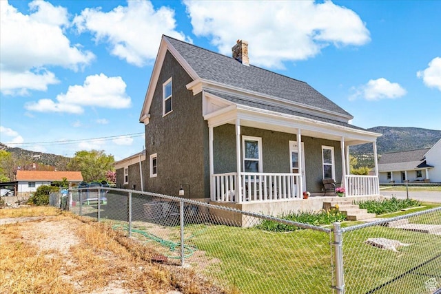 193 S Main E, Manti, UT 84642 - view of front of home featuring a shingled roof, stucco siding, a porch, and a chimney