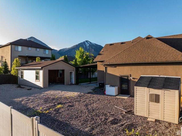 384 N 710 E, Salem, UT 84653 - view of front of home with an outdoor structure, a mountain view, a shed, and fence