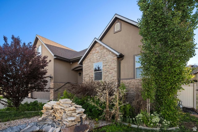 384 N 710 E, Salem, UT 84653 - view of property exterior with stone siding, stucco siding, a garage, and fence
