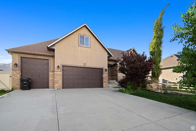 384 N 710 E, Salem, UT 84653 - view of front of home with stucco siding, stone siding, concrete driveway, an attached garage, and roof with shingles