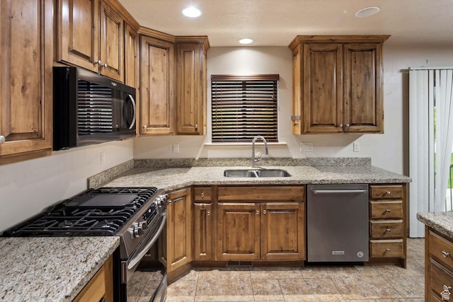 384 N 710 E, Salem, UT 84653 - kitchen with stainless steel appliances, a sink, brown cabinetry, light stone countertops, and recessed lighting