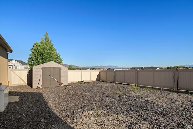 384 N 710 E, Salem, UT 84653 - fenced backyard featuring a storage unit, a gate, an outbuilding, and a mountain view