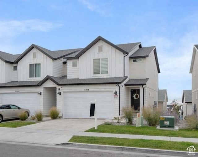 8578 W Bowie Dr, Magna, UT 84044 - view of front of house with board and batten siding, a garage, and concrete driveway
