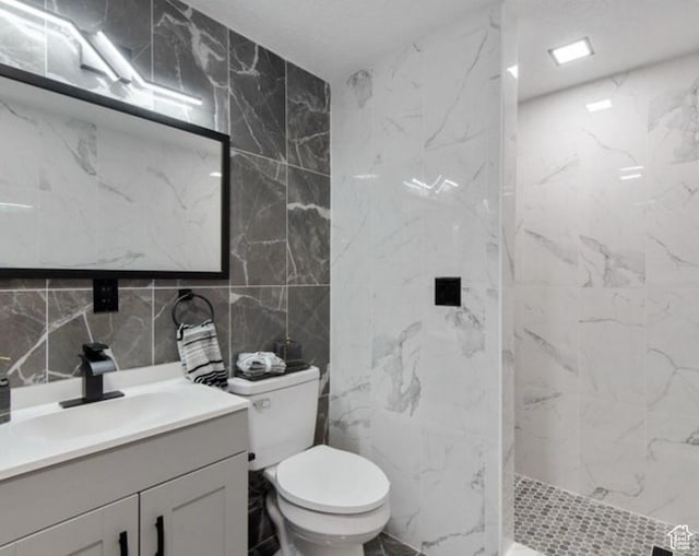 8578 W Bowie Dr, Magna, UT 84044 - full bath featuring tile walls, vanity, a marble finish shower, toilet, and backsplash