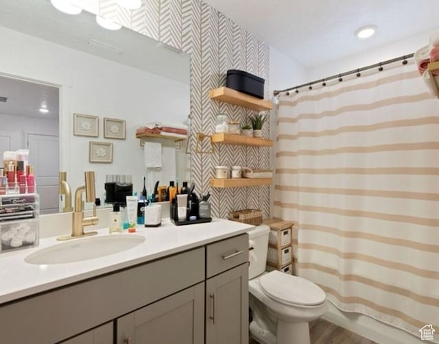 8578 W Bowie Dr, Magna, UT 84044 - full bathroom with vanity, toilet, wood finished floors, and a shower with curtain