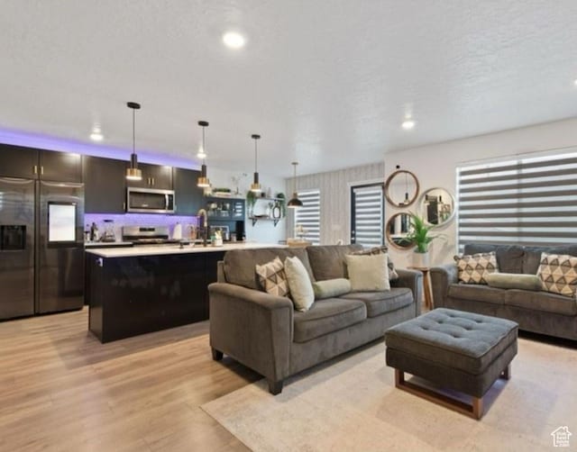 8578 W Bowie Dr, Magna, UT 84044 - living room with light wood finished floors and recessed lighting