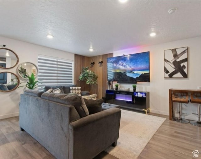 8578 W Bowie Dr, Magna, UT 84044 - living area featuring wood finished floors, baseboards, recessed lighting, and a textured ceiling