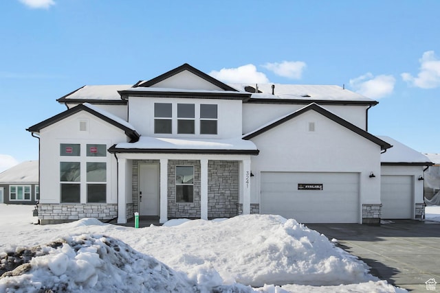 view of front of house featuring stone siding, concrete driveway, stucco siding, and an attached garage