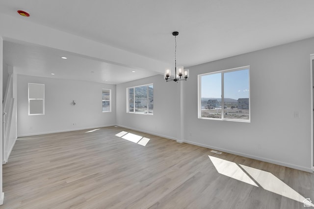 unfurnished dining area featuring healthy amount of natural light, a chandelier, baseboards, light wood-style floors, and recessed lighting