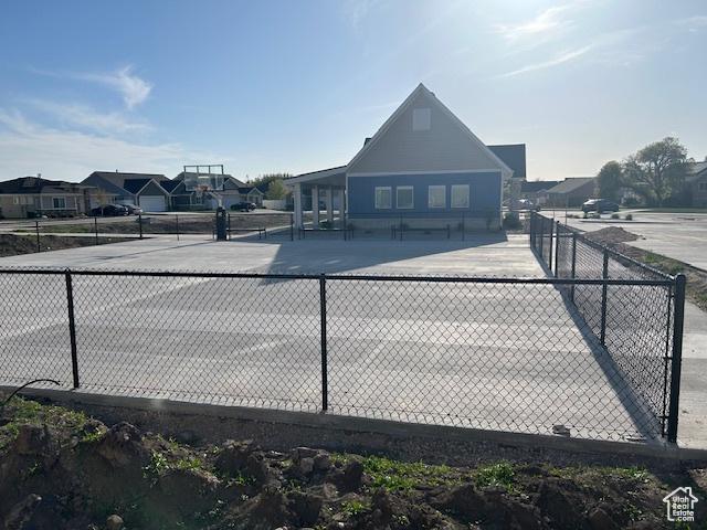 view of tennis court with fence