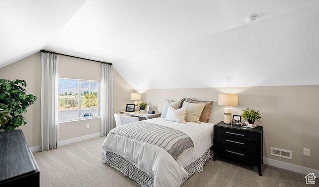 bedroom with vaulted ceiling, carpet, and baseboards