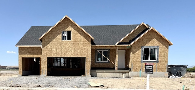 property in mid-construction featuring roof with shingles and a porch
