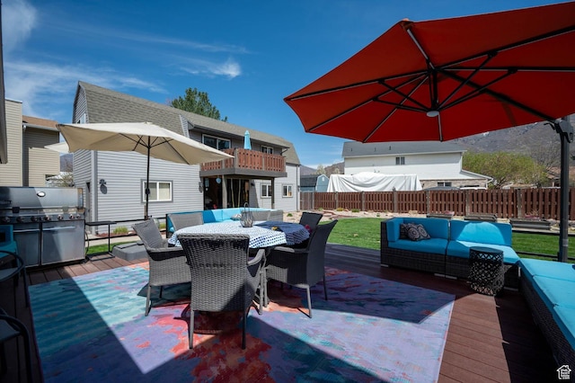 wooden terrace with an outdoor hangout area, a fenced backyard, and outdoor dining area