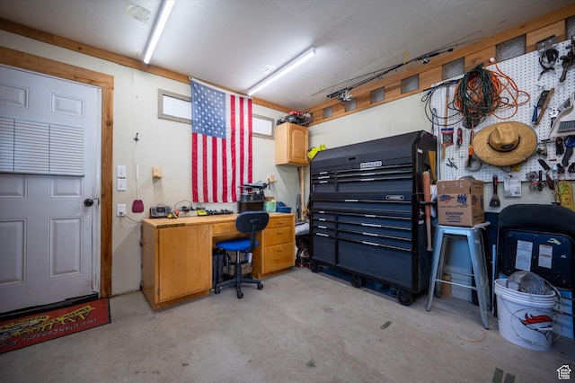 office space with unfinished concrete flooring and a workshop area