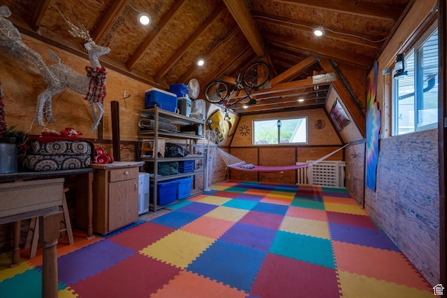 recreation room with tile patterned floors and vaulted ceiling