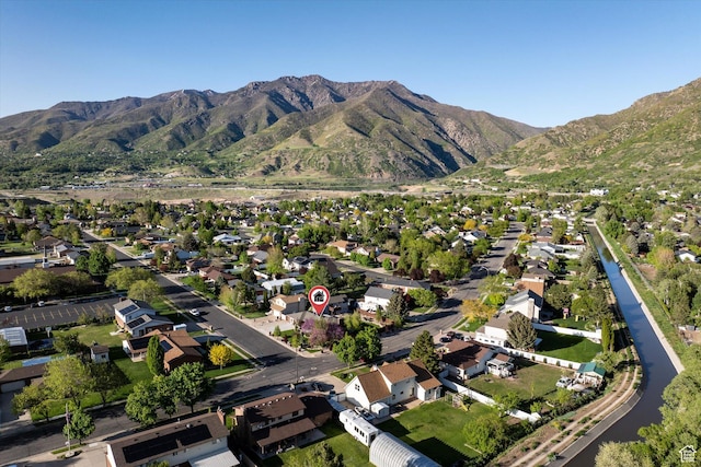 aerial overview of property's location featuring nearby suburban area and a mountainous background