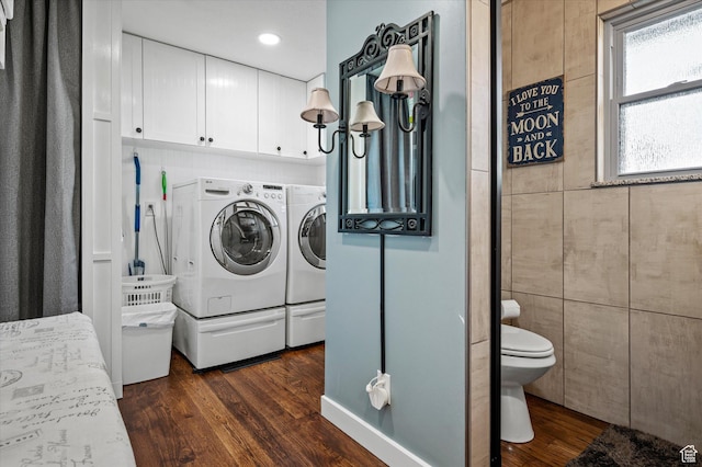 washroom with washing machine and clothes dryer, dark wood-style flooring, cabinet space, and recessed lighting