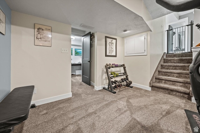 basement with baseboards, carpet flooring, and stairs