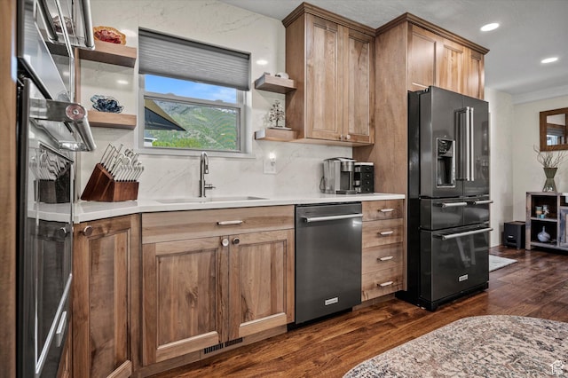 kitchen featuring black fridge, open shelves, stainless steel dishwasher, dark wood-style floors, and a sink