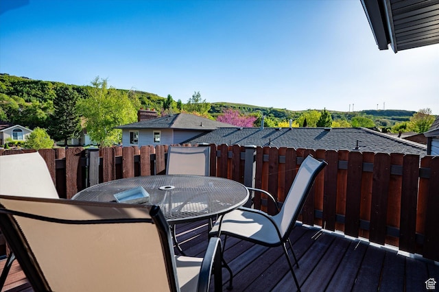 wooden terrace featuring fence and outdoor dining space
