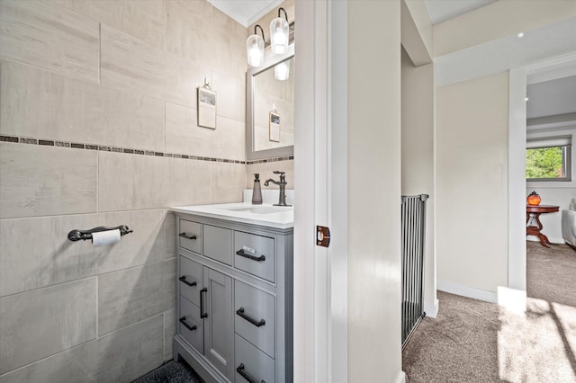bathroom with tile walls, vanity, and ornamental molding