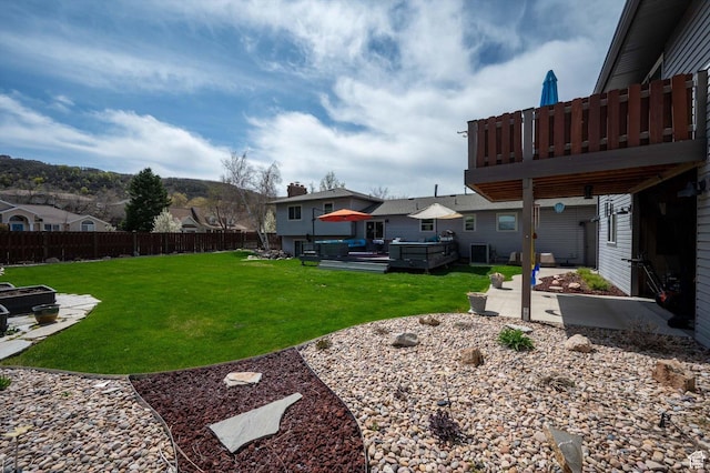 view of yard featuring a patio, a residential view, and a deck