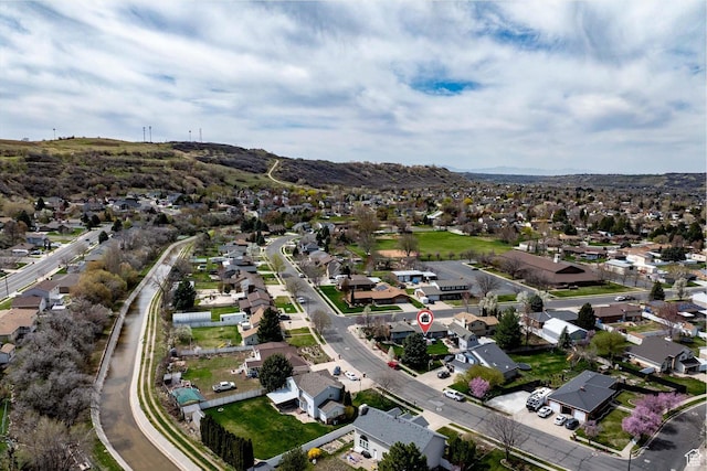 aerial view of property's location with nearby suburban area and a mountain backdrop