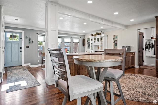 dining area featuring recessed lighting, ornamental molding, dark wood-style flooring, baseboards, and beamed ceiling