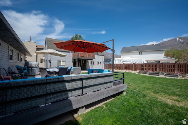 view of yard featuring an outdoor living space, a vegetable garden, and a deck with mountain view