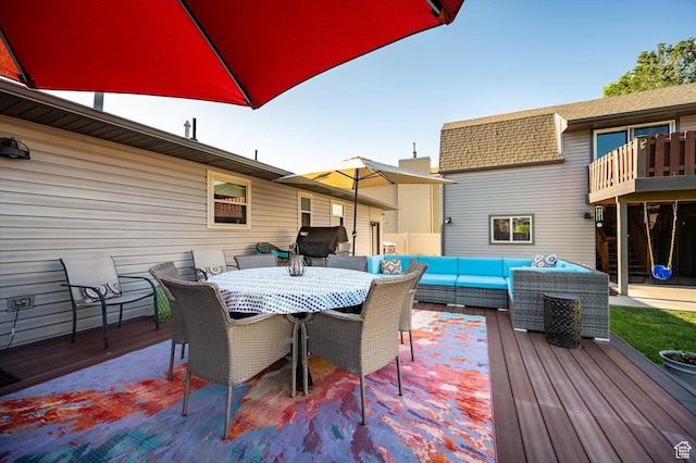 wooden terrace featuring outdoor lounge area and outdoor dining space